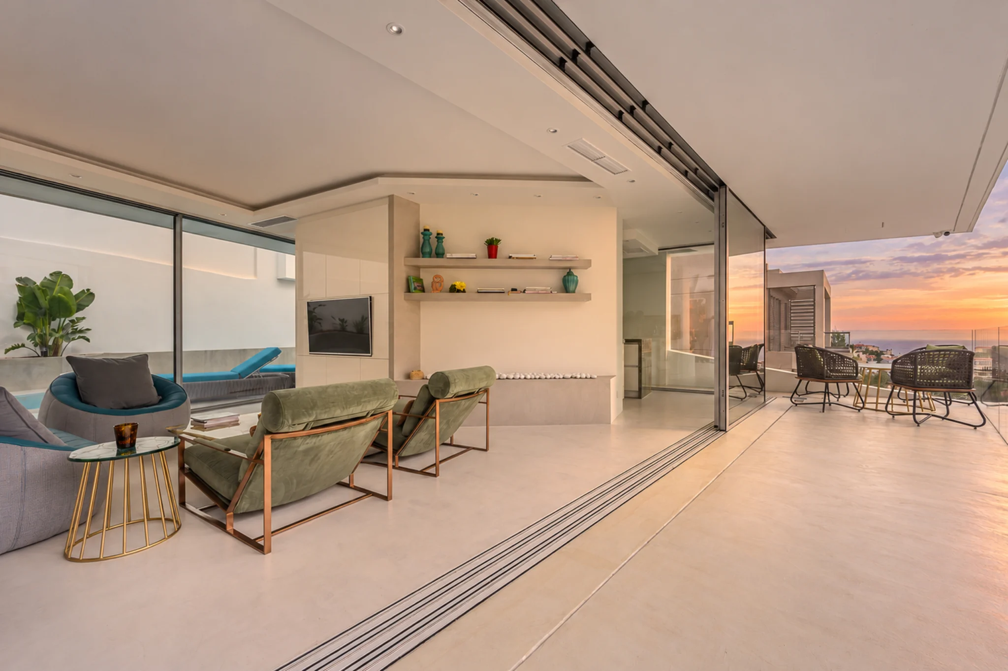 Open living room and terrace with a sunset view at Contemporary Minimalistic Villa, Athens, Attica, Greece.