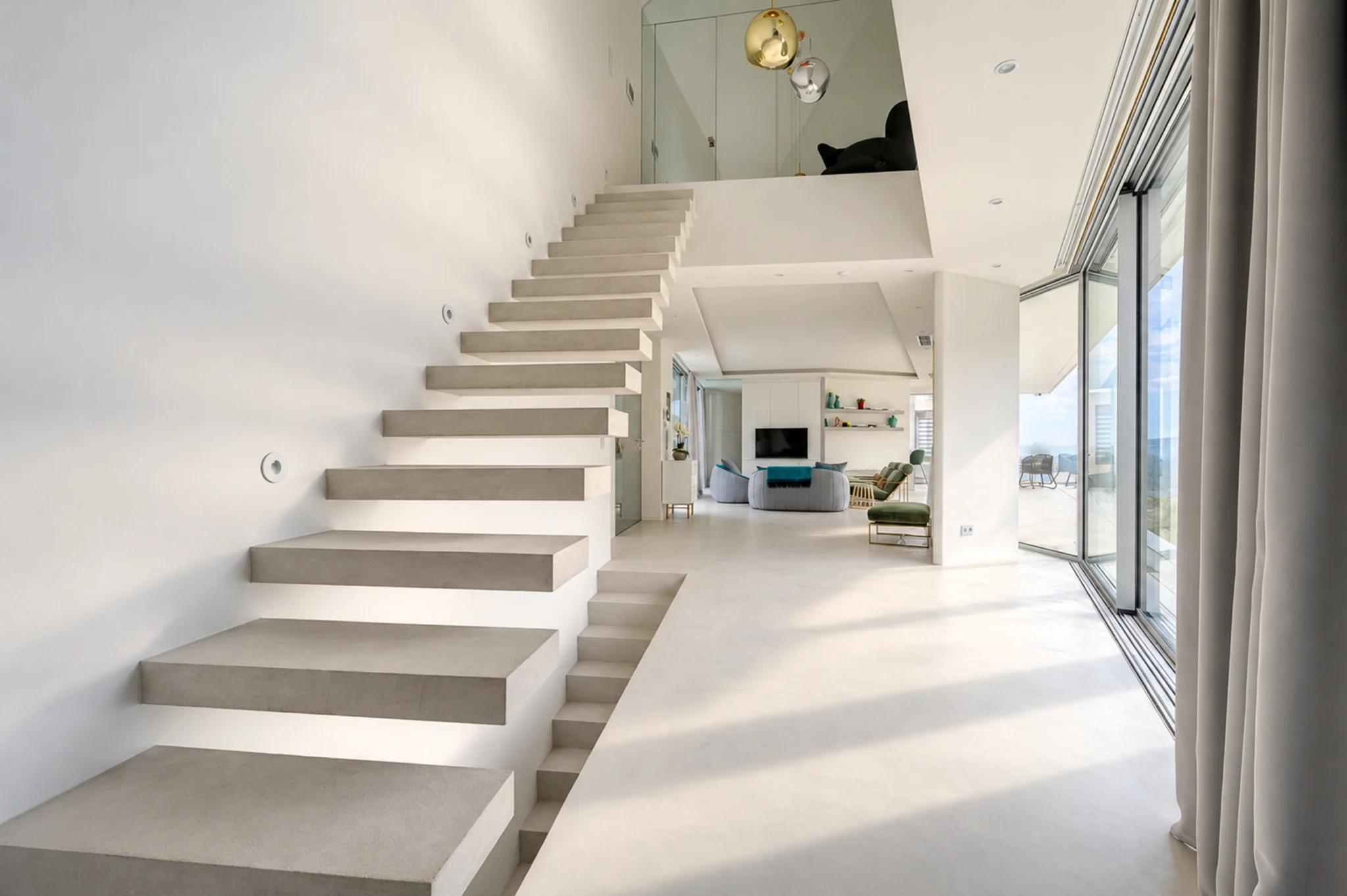 Floating staircase beside a bright glazed wall at Contemporary Minimalistic Villa, Athens, Attica, Greece.