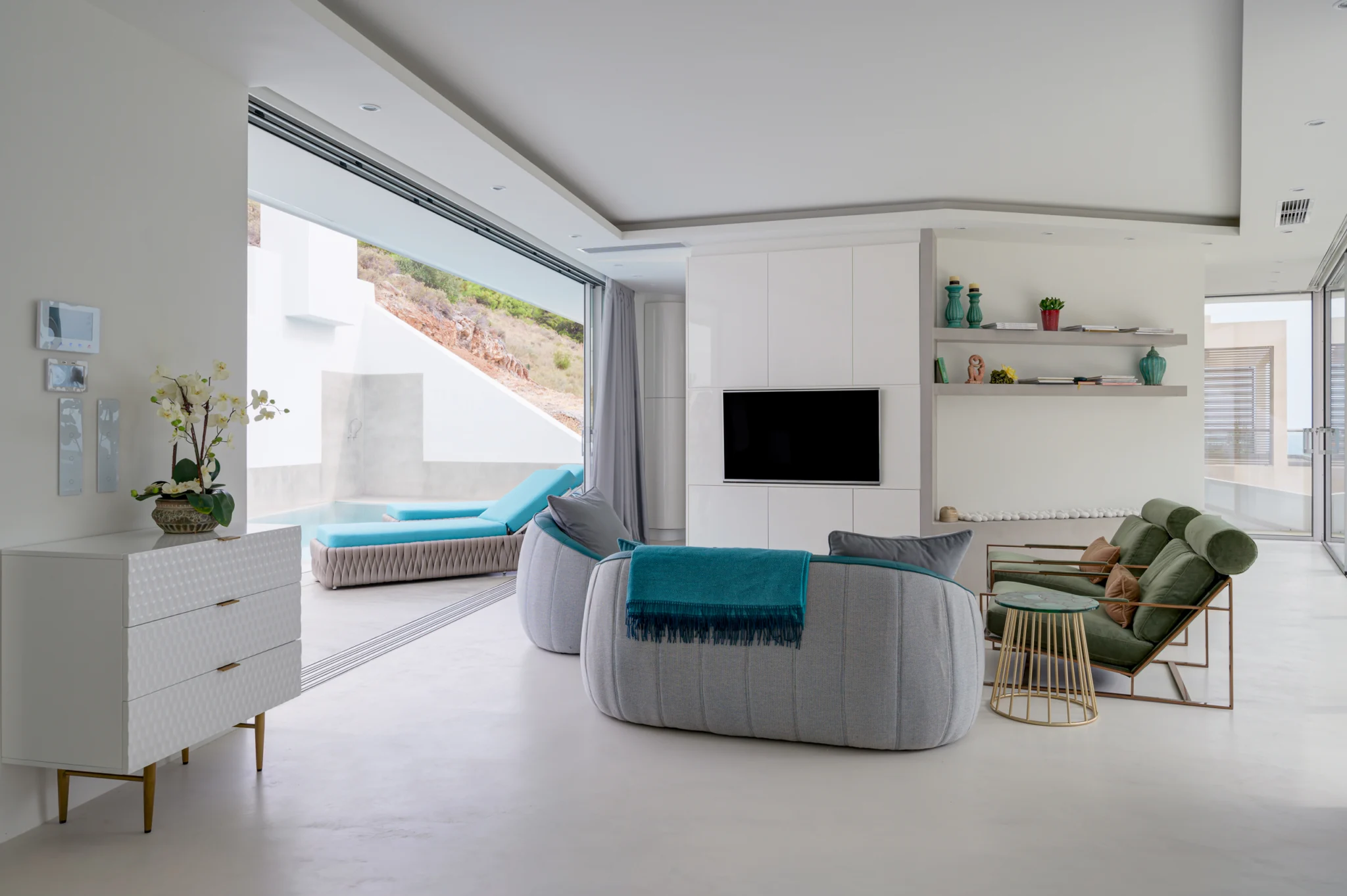 Living room with curved seating and an open view to the pool at Contemporary Minimalistic Villa, Athens, Attica, Greece.