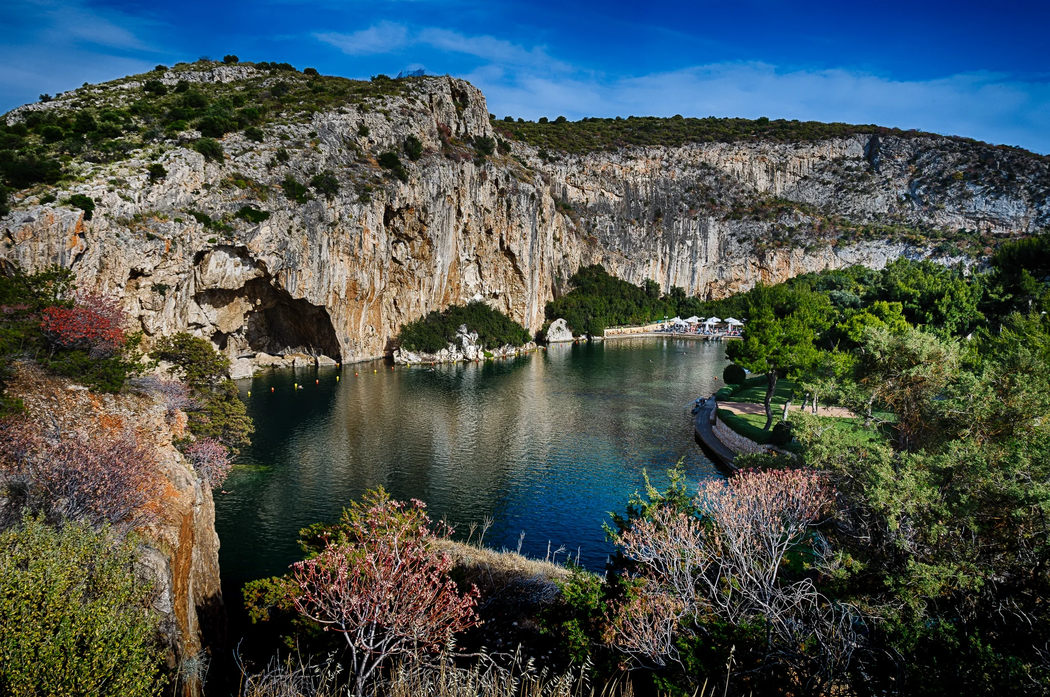 Sheltered coastal cove enclosed by steep rock and trees