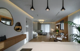 View from the kitchen island towards the dining table and living room in a luxury apartment in northern Athens.