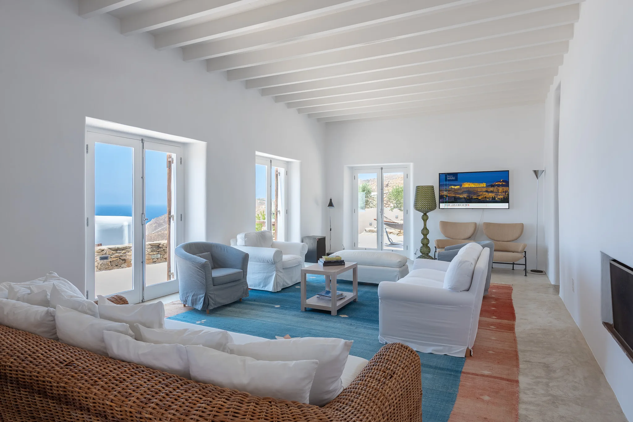 Bright white living room with timber accents and a wide sea view