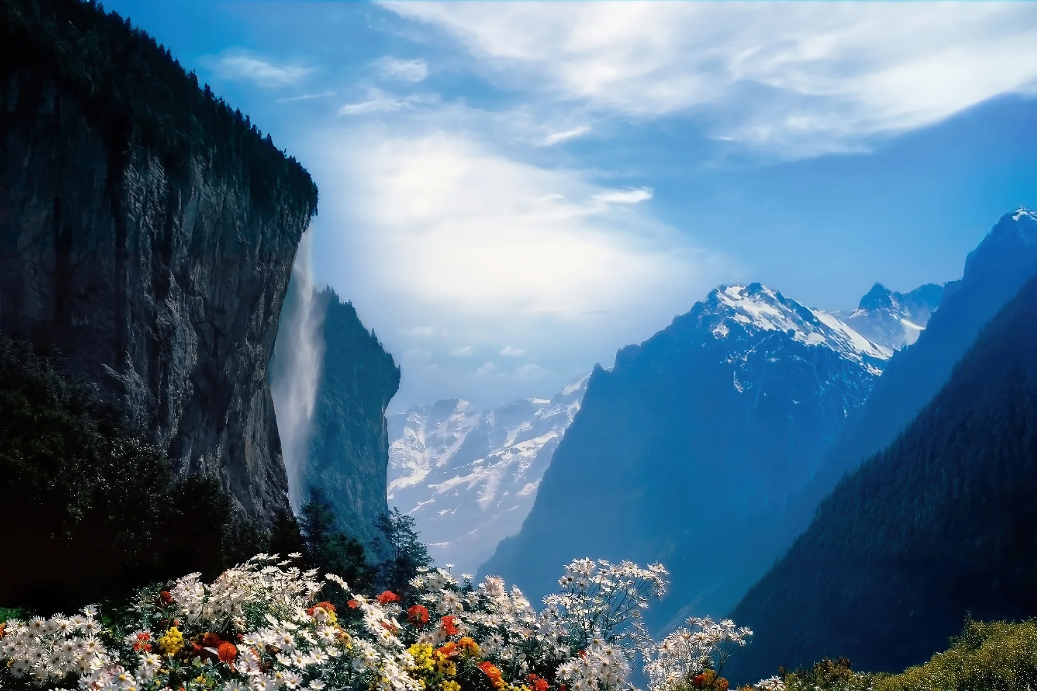Lauterbrunnen Valley with Staubbach Falls alpine peaks and flowers in Switzerland