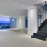 Black staircase in an illuminated white interior at twilight at Luxury Residence Blackstone.