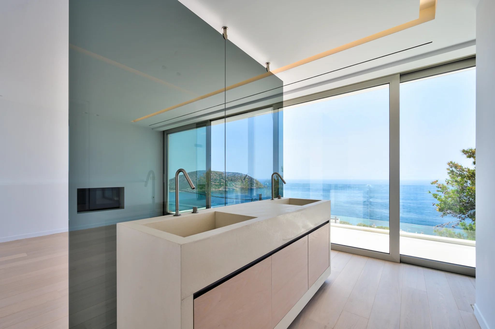 Freestanding basin with twin taps, a glass partition and a sea-facing window at Luxury Residence Blackstone.