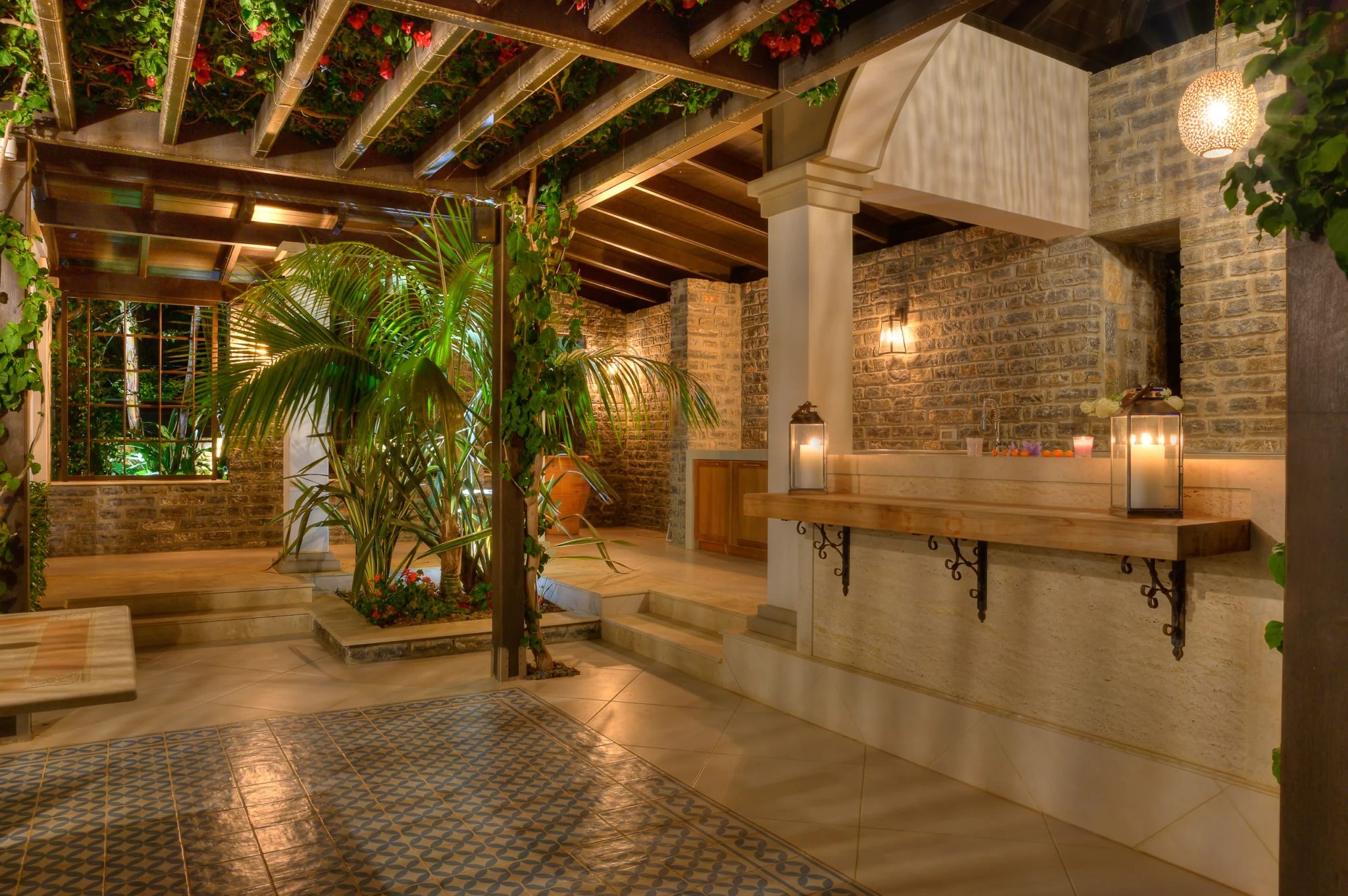 Stone terrace and sheltered outdoor dining area at night at Mirum Villas, Crete, Greece