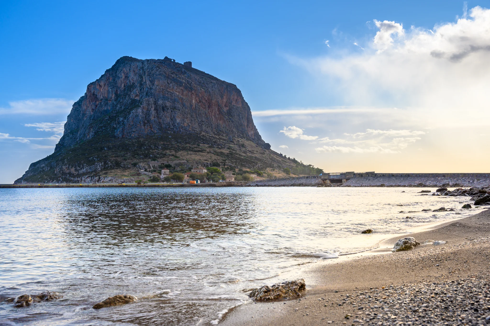 Monemvasia rock and fortified settlement seen from the shore in Greece