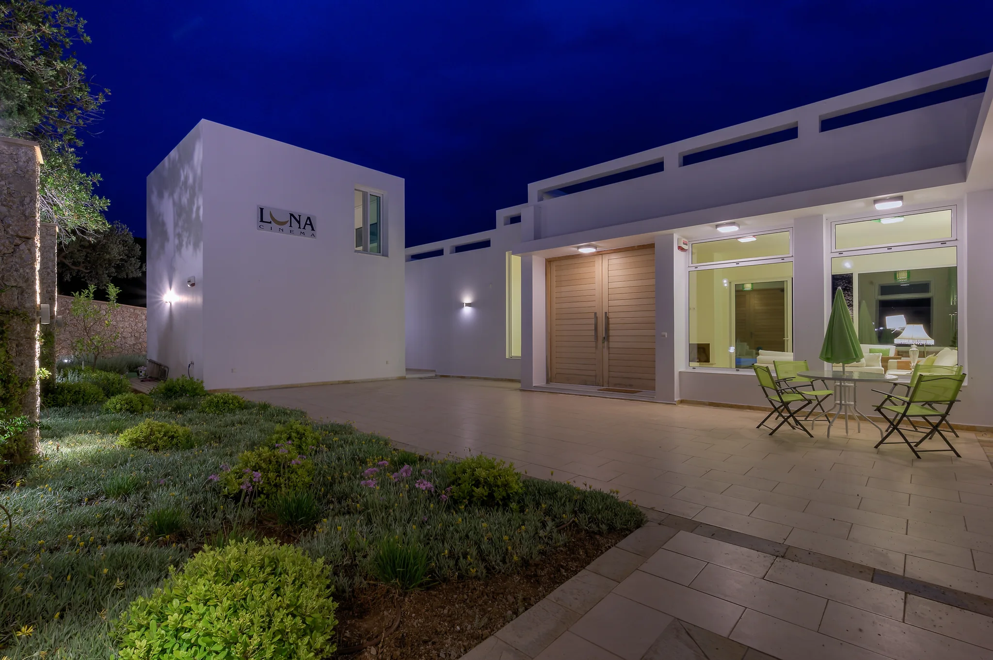Modern villa and reflecting pool photographed at blue hour