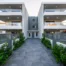 Symmetrical residential buildings around a central paved entrance at Residential Complex in Athens, Athens, Attica, Greece.