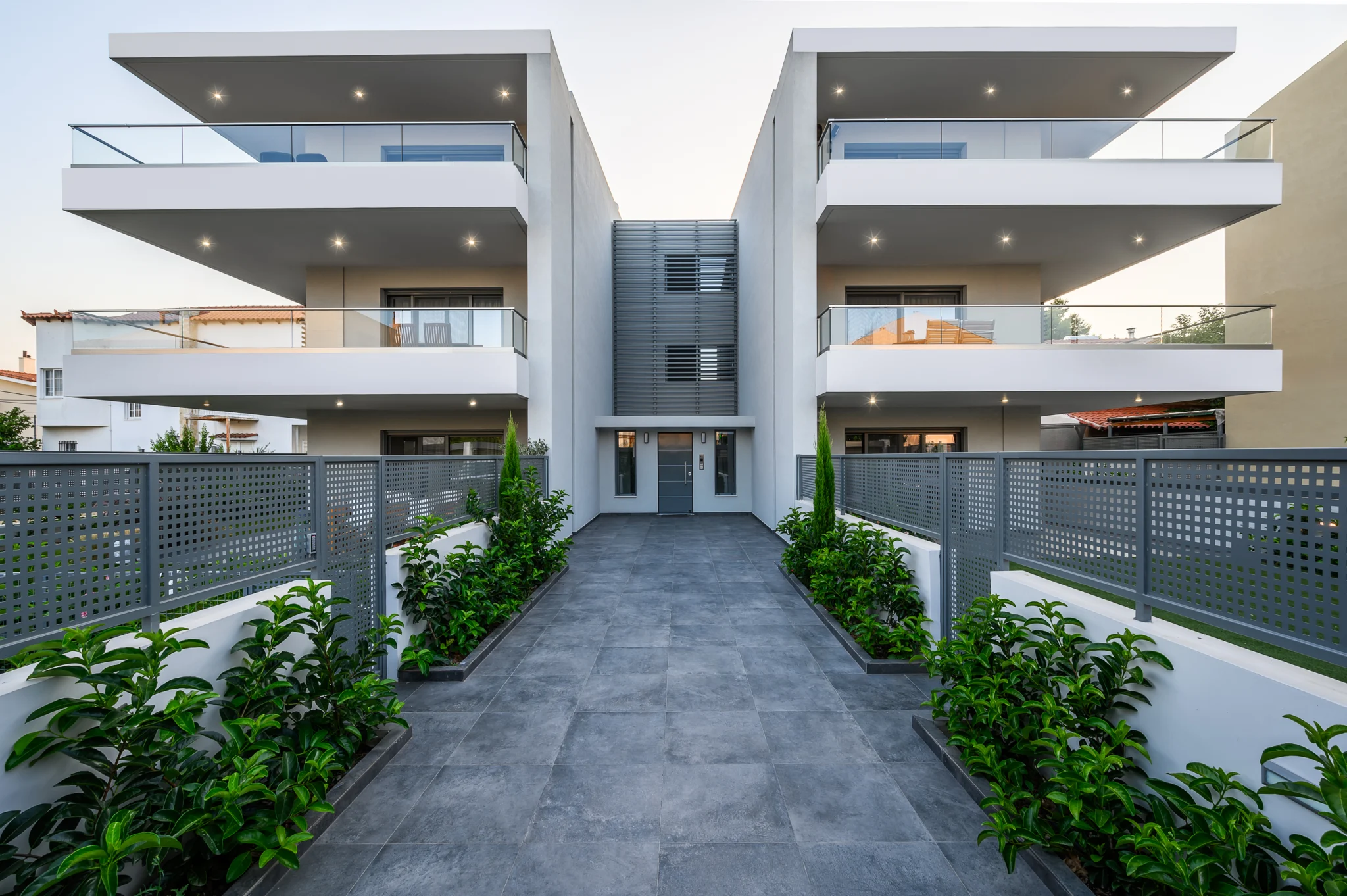Symmetrical residential buildings around a central paved entrance at Residential Complex in Athens, Athens, Attica, Greece.