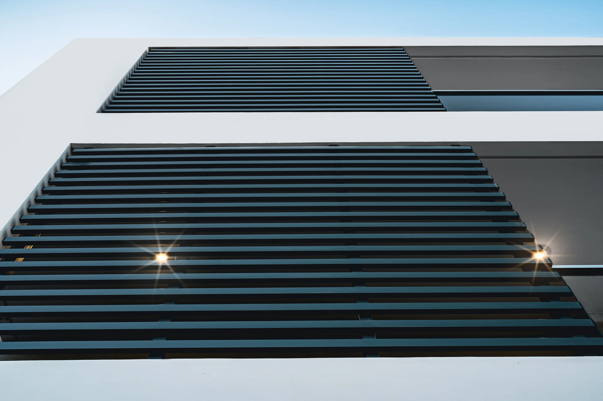 Horizontal facade screens with integrated exterior lighting at Residential Complex in Athens, Athens, Attica, Greece.