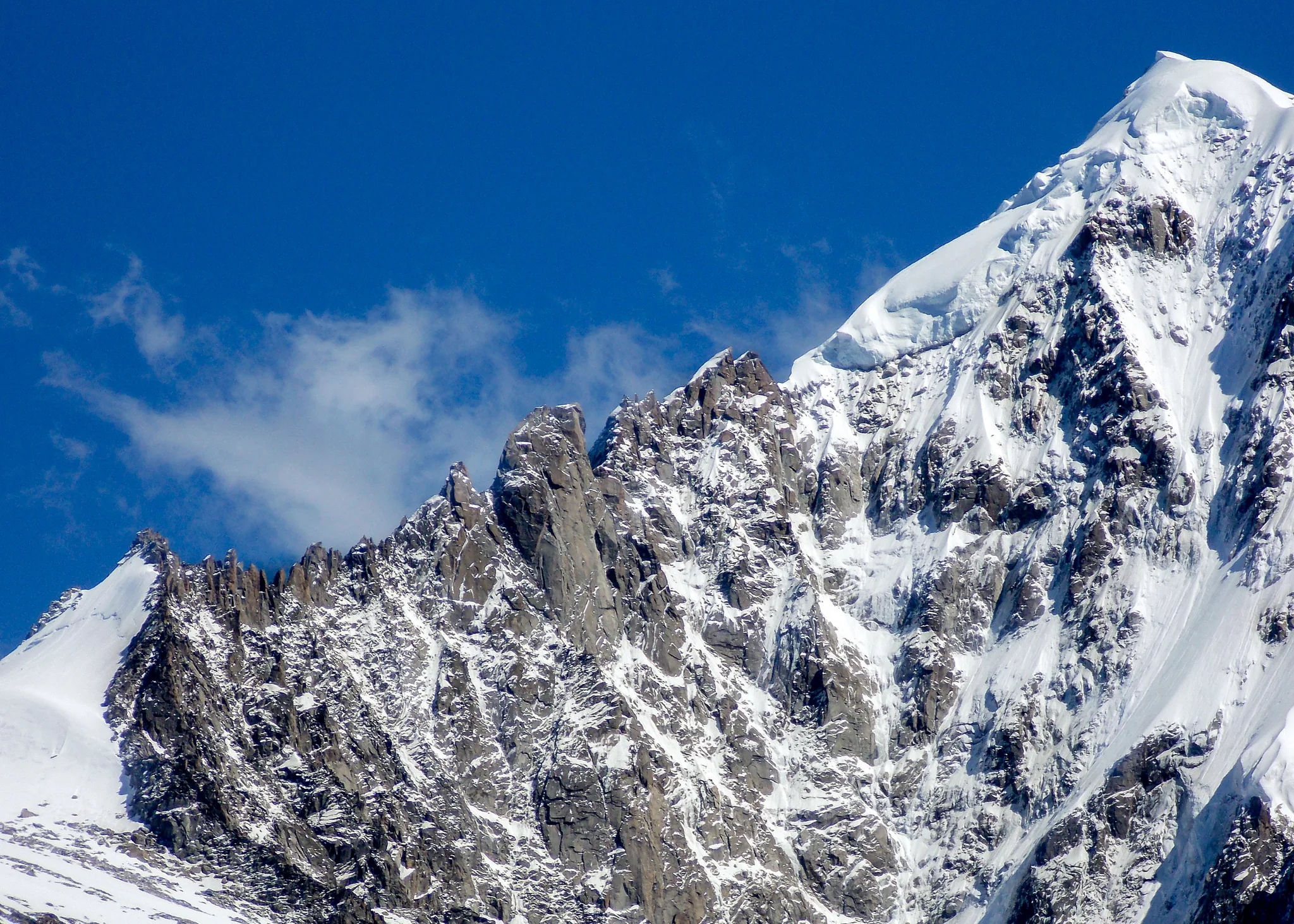 Close view of snow and ice across a jagged alpine mountain peak