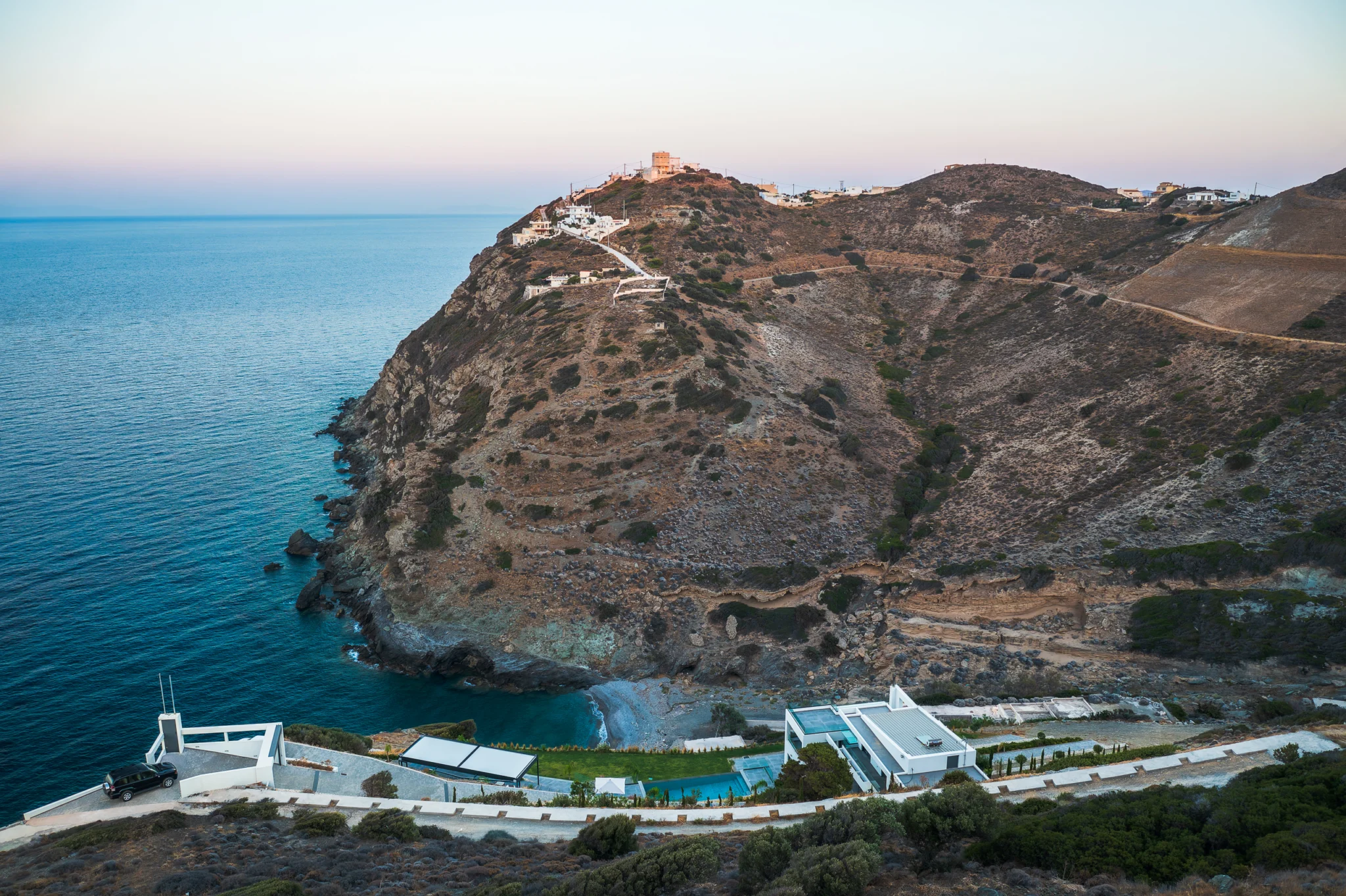 Aerial view of a coastal villa, pool and surrounding rocky headland at Villa in Athens, Athens, Attica, Greece.