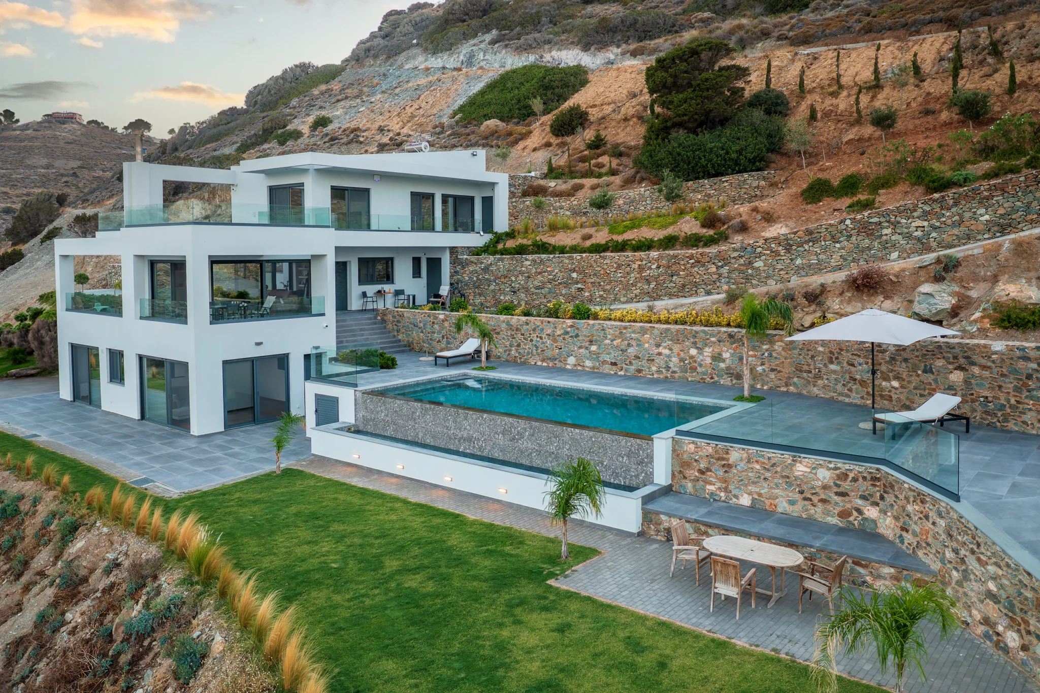 Aerial view of the villa and pool within terraced hillside grounds at Villa in Athens, Athens, Attica, Greece.