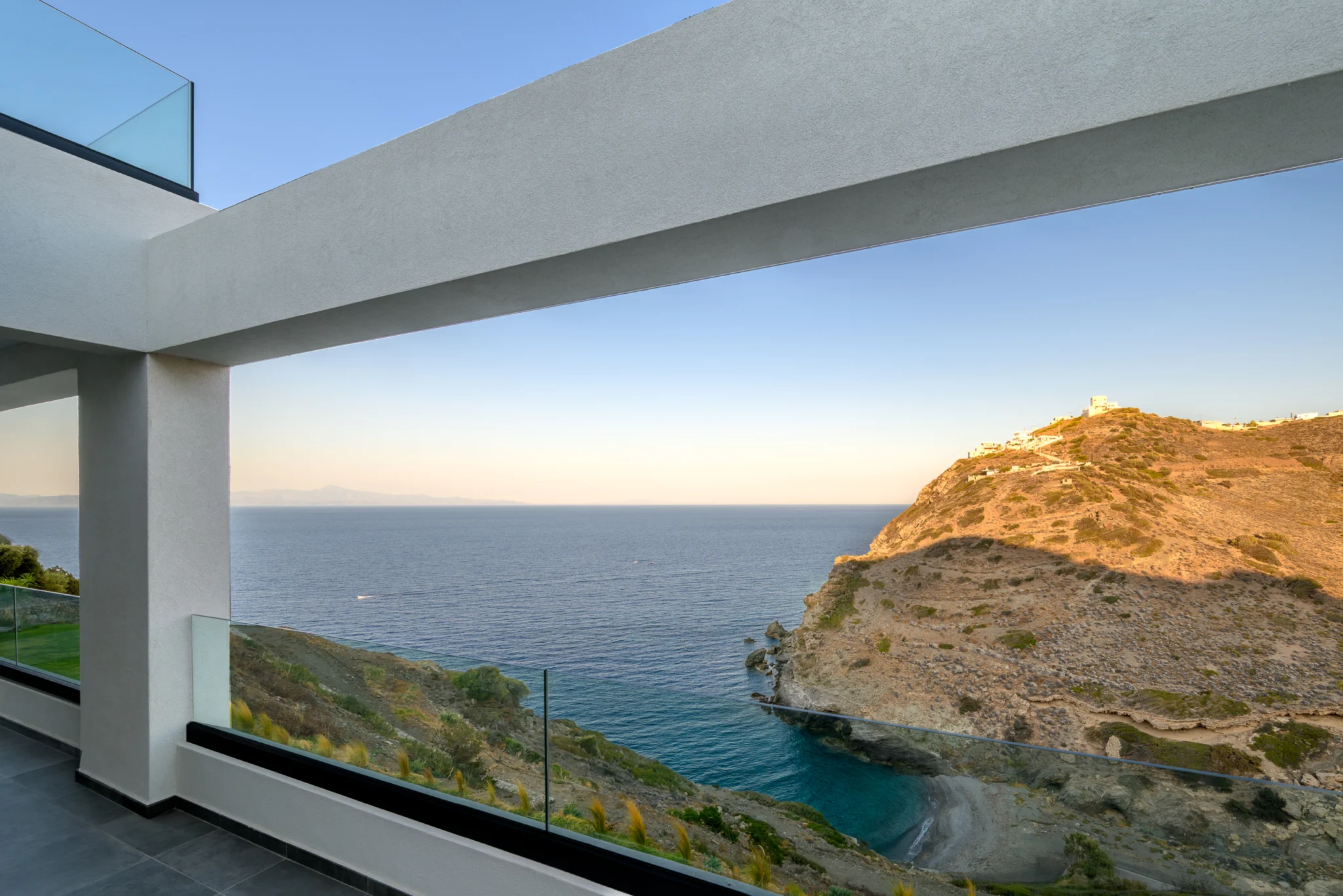 Balcony opening framing the sea and rocky coastline at Villa in Athens, Athens, Attica, Greece.