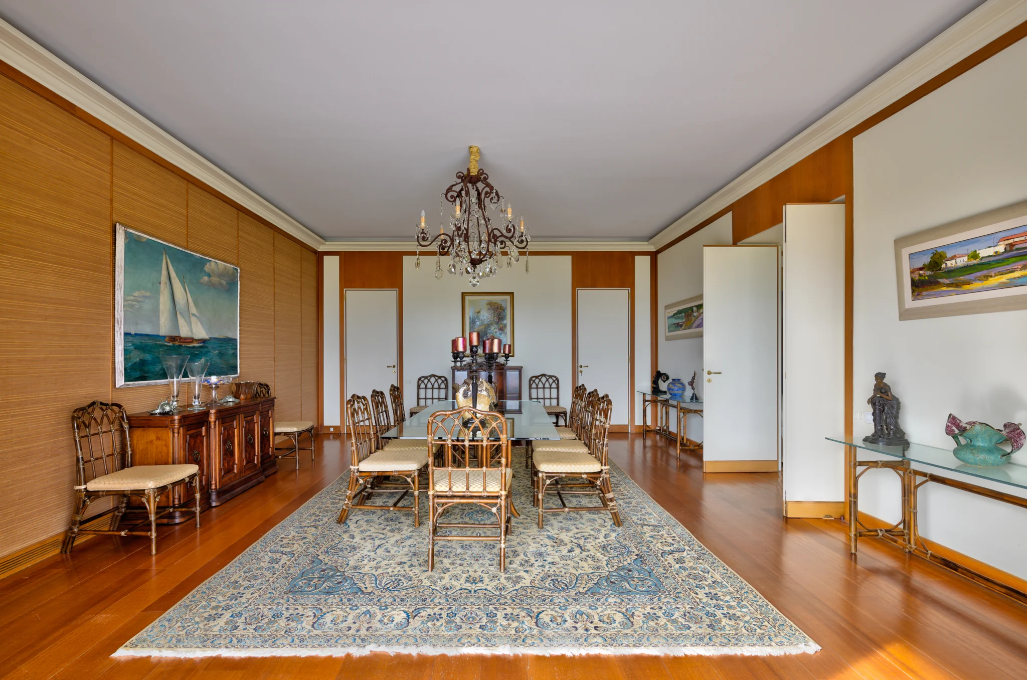 Dining table, decorative chairs and sailing artwork at Villa Icarus.