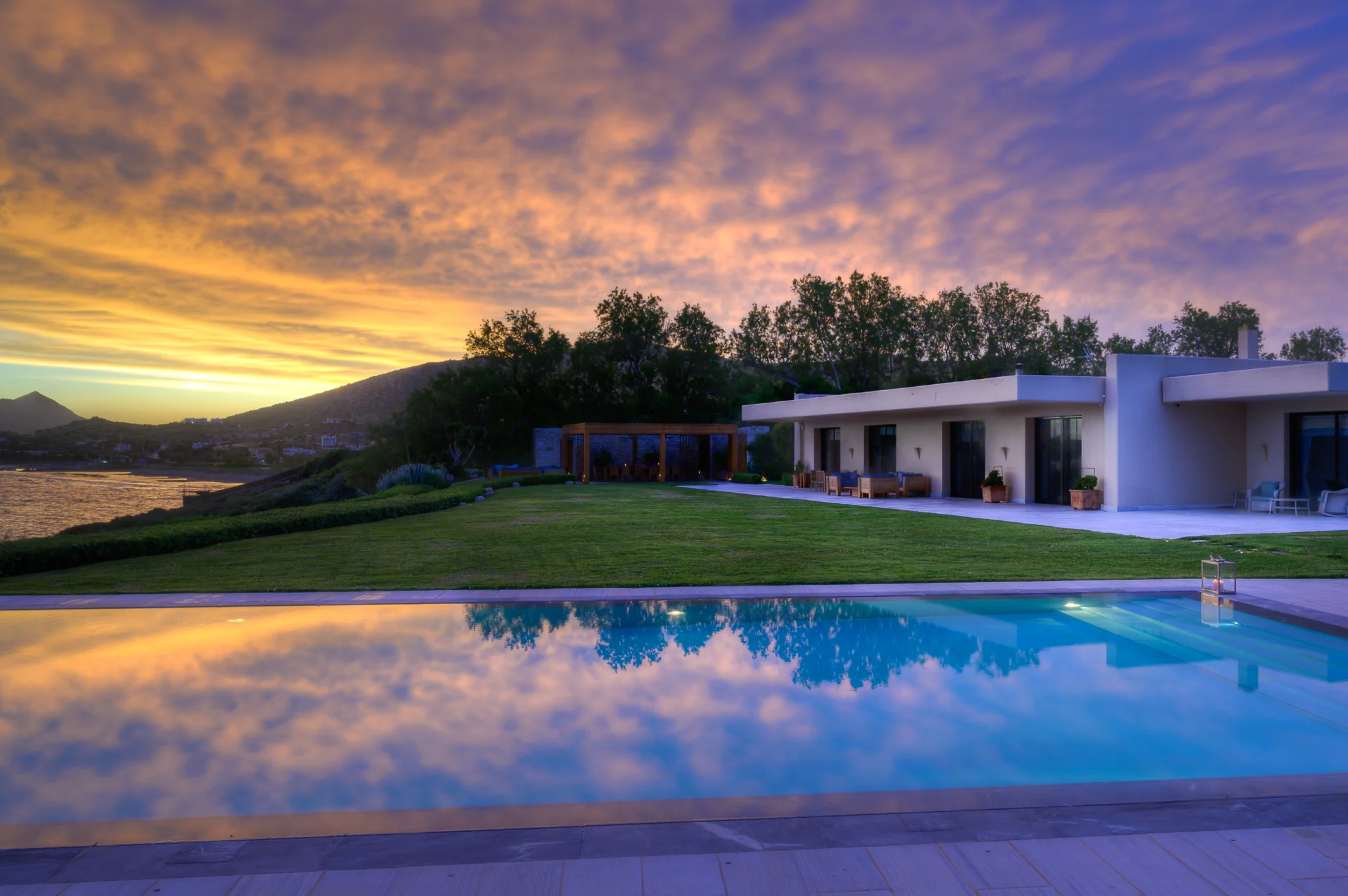 Sunset sky reflected in the pool beside the villa at Villa Icarus.